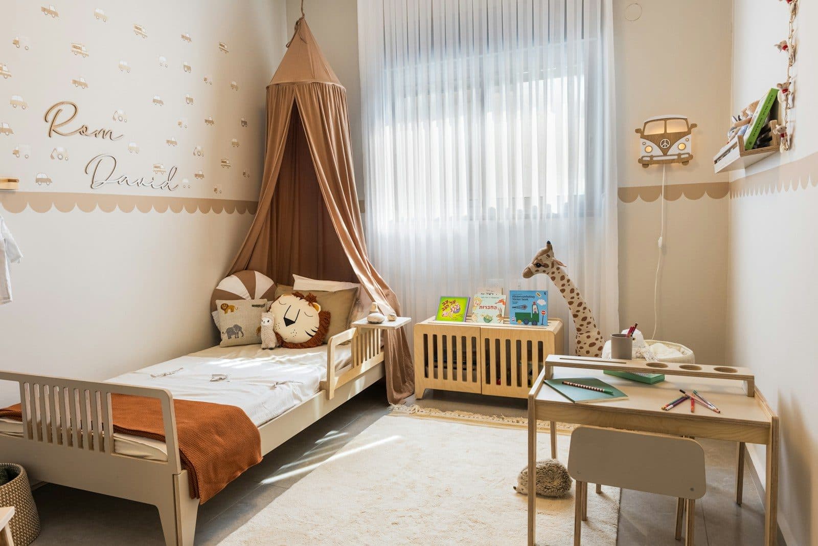 Pencere önünde tül perdeli, sıcak tonlu çocuk odası
